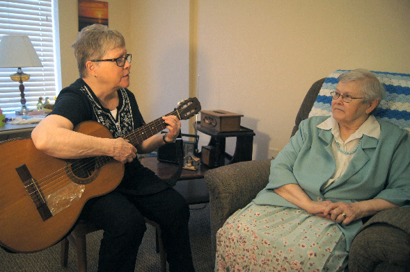Sister Mary Susan Dewitt plays for a resident in the Memory Care haven at Benedictine Living Community of Duluth