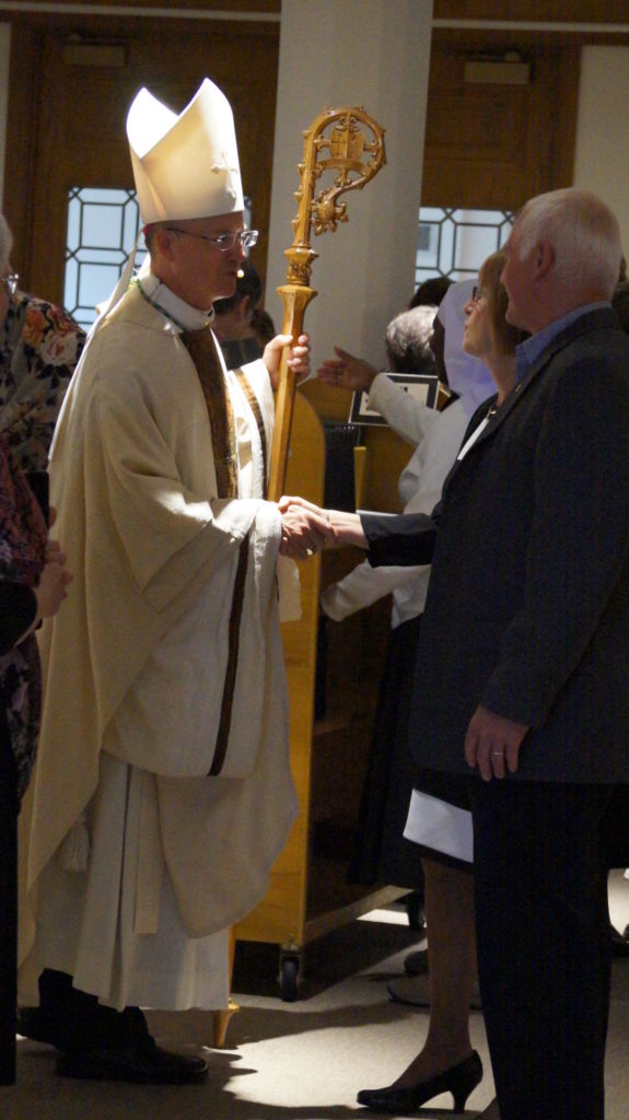 Bishop Paul Sirba greets attendees at the Monastery's 125th anniversary Mass.