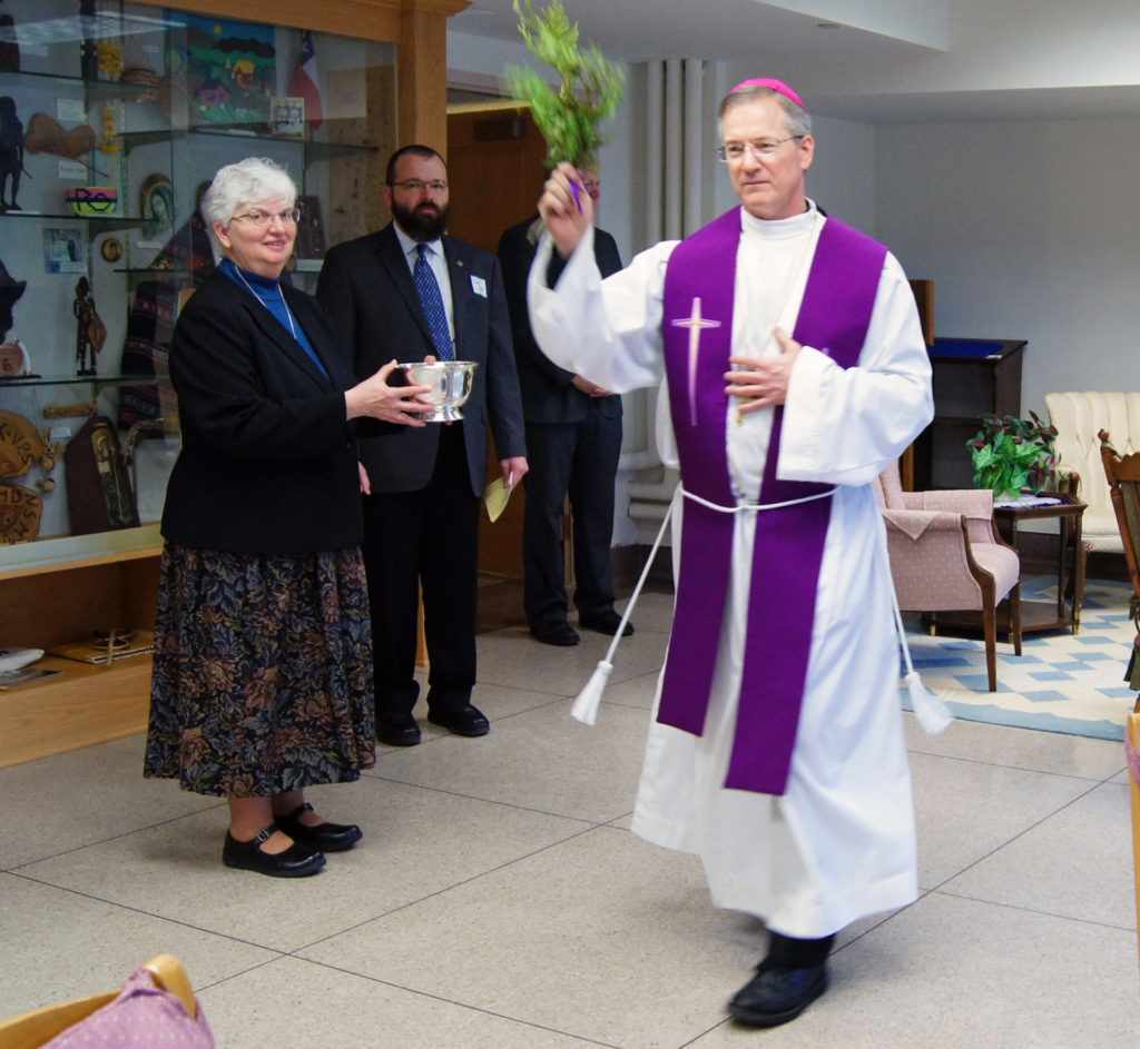 Bishop Paul Sirba blesses one of the meeting rooms at the Community's Center for Spirituality and Enrichment.