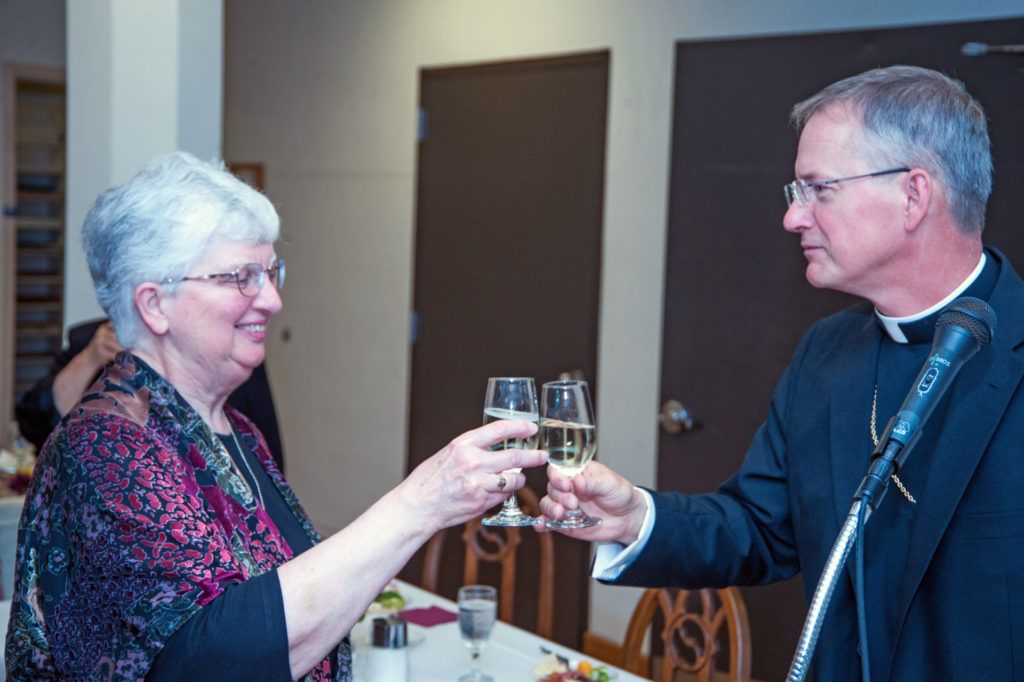 Bishop Paul Sirba and Prioress Beverly Raway share a toast at the dinner celebrating our 125th anniversary in 2017.