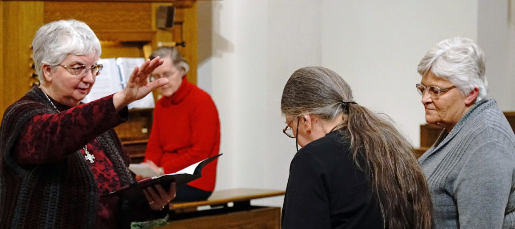 Sister Beverly Raway blesses the Director and new postulant.
