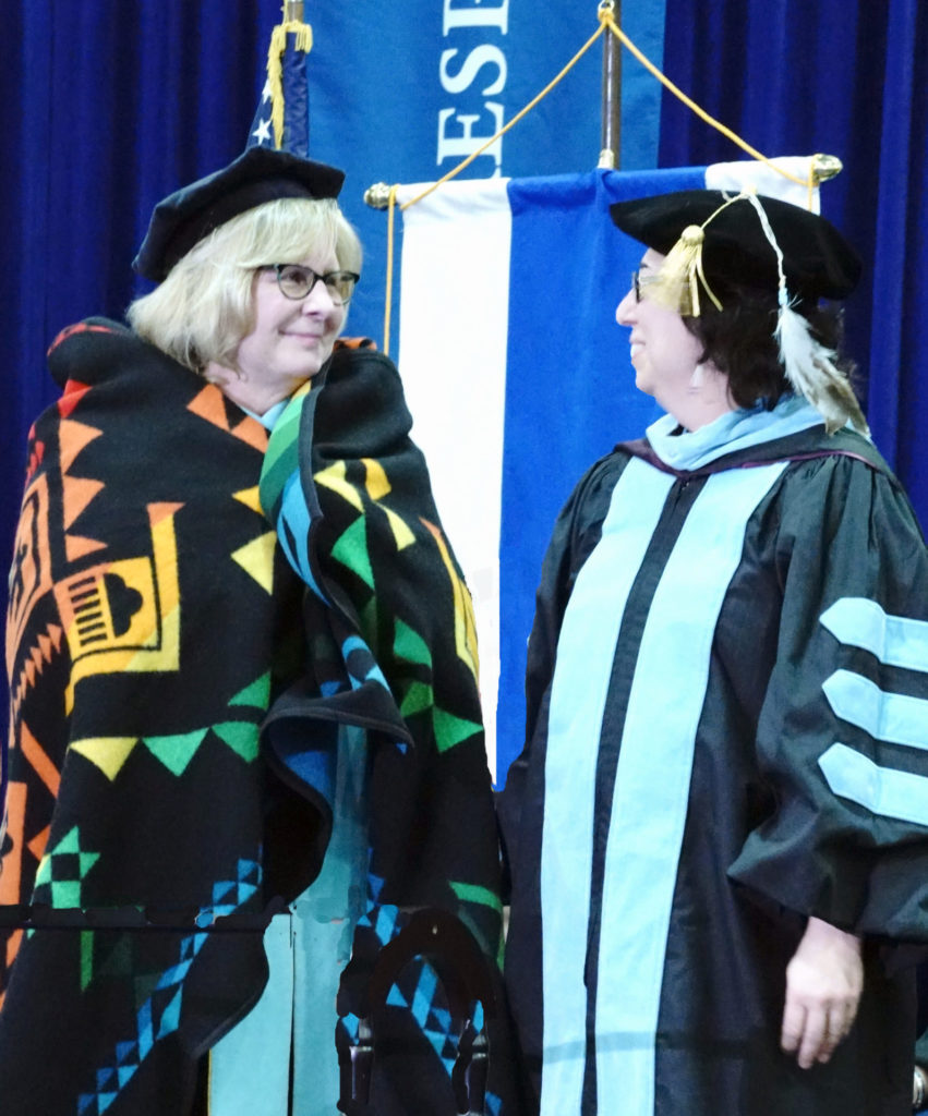 Barbara McDonald receives Shared Spirits blanket from Amy Bergstrom.